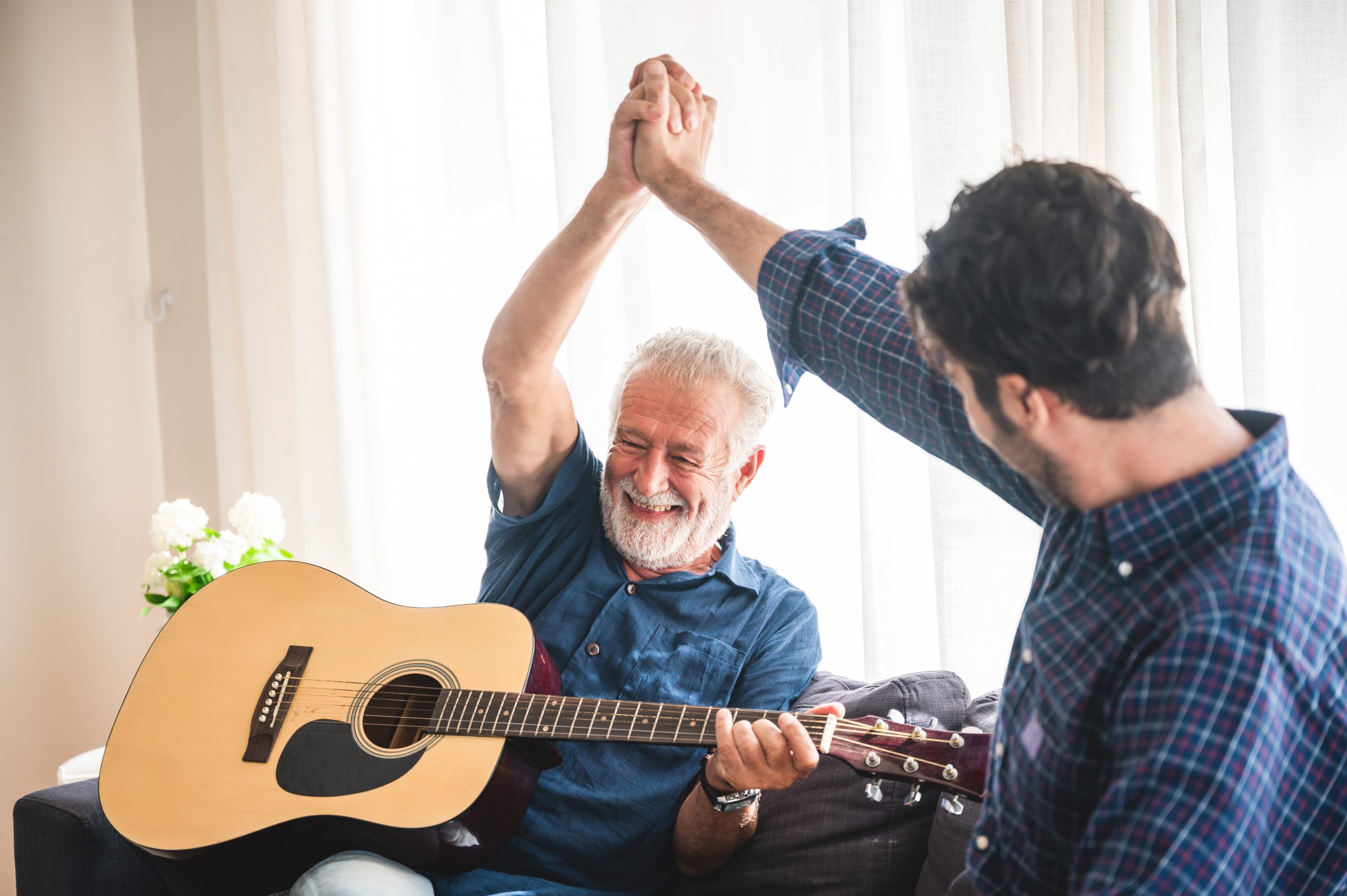 elderly dad and son are playing music at home, relax activity at home with family